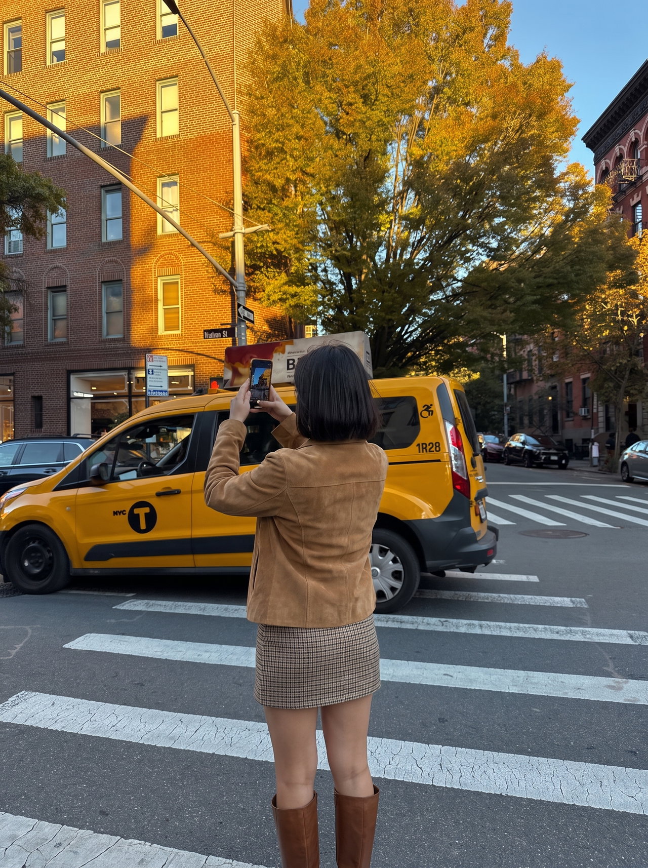 Woman Photographing Yellow Taxi in Autumn