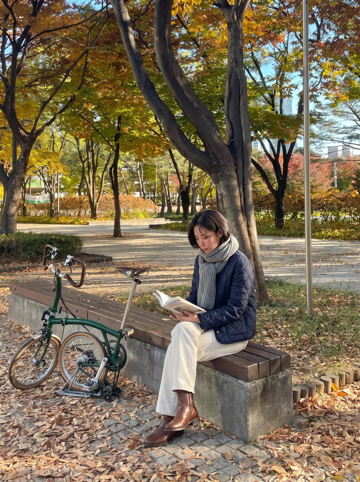 Woman Reading on Park Bench in Autumn