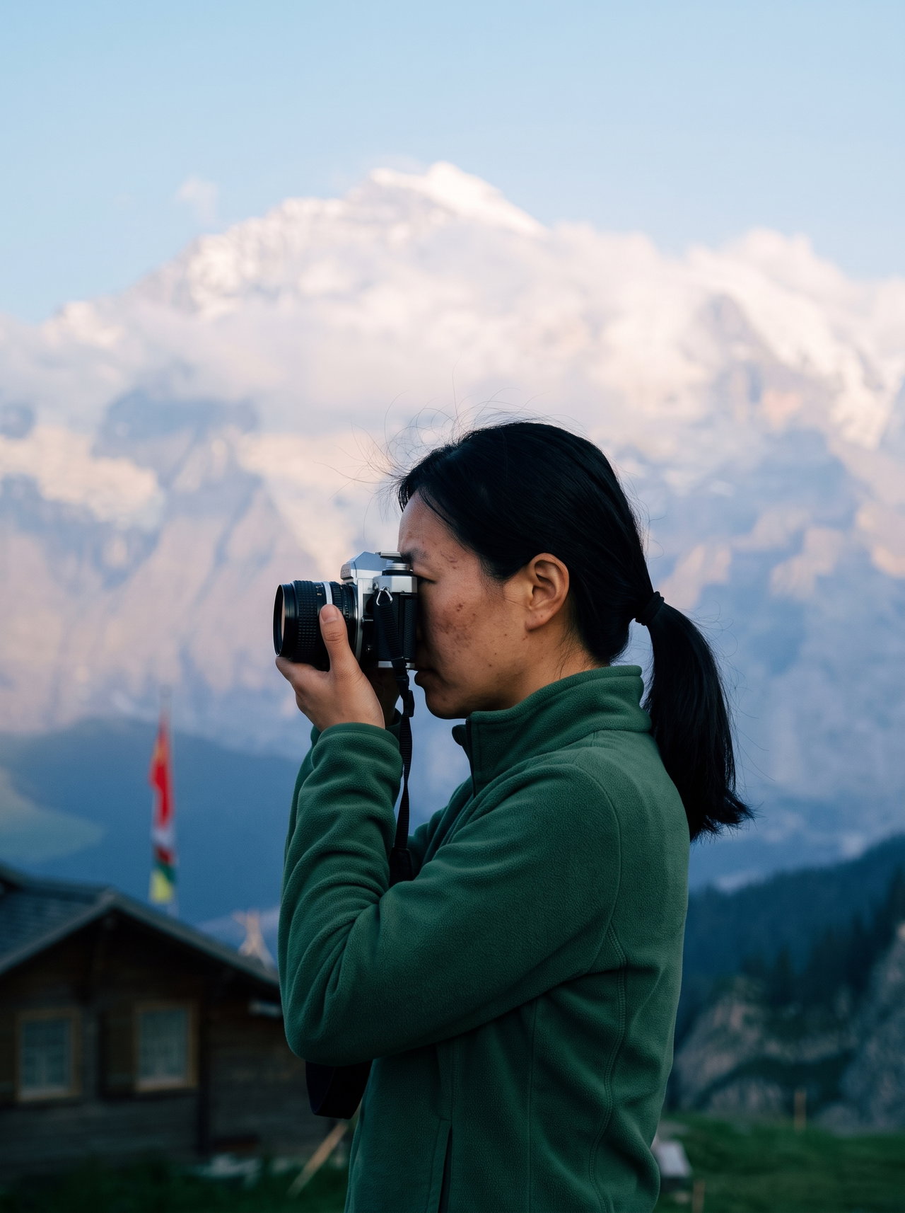 Photographer in Mountains at Dusk