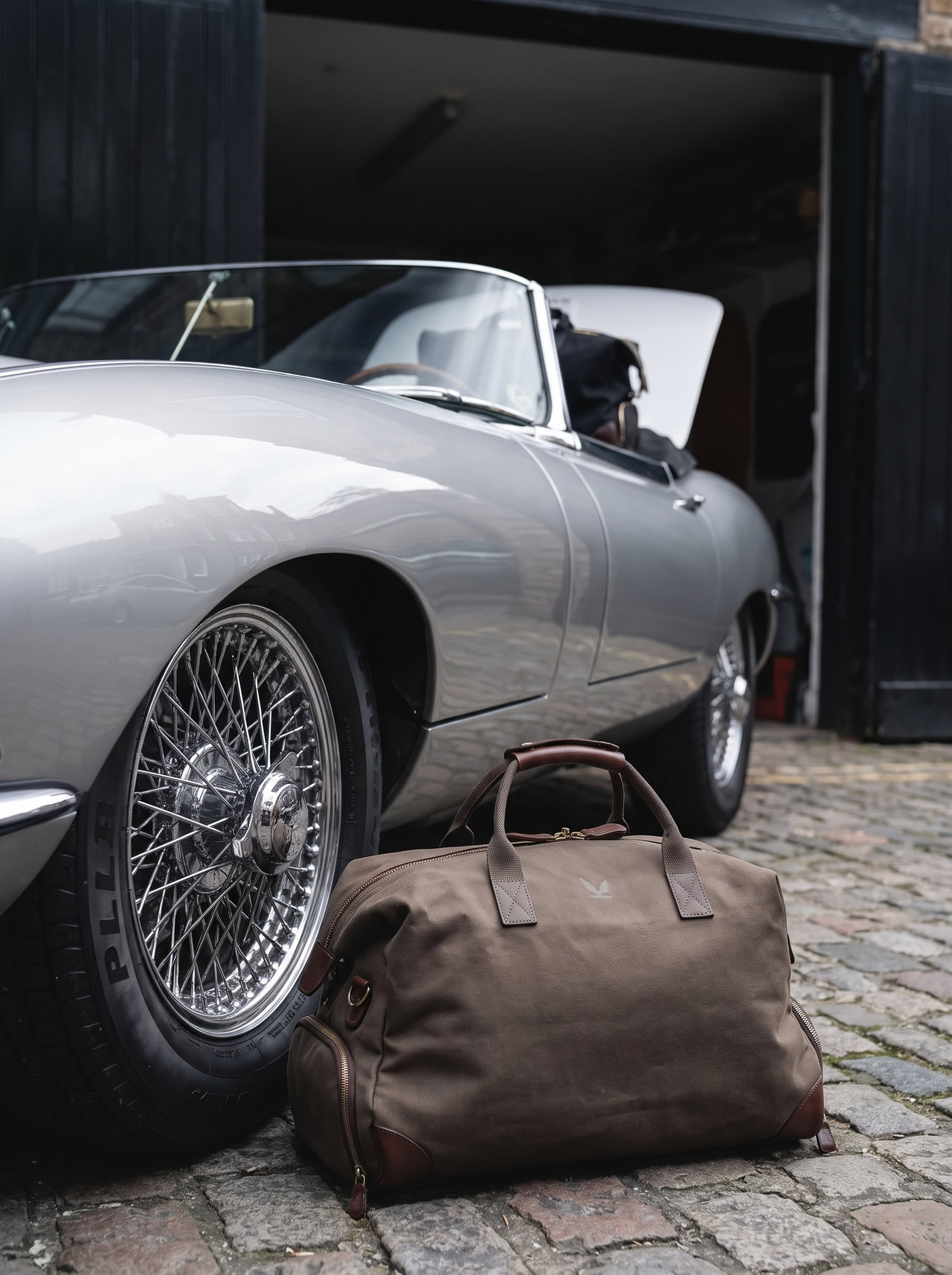 Silver Jaguar E-Type with Leather Weekend Bag