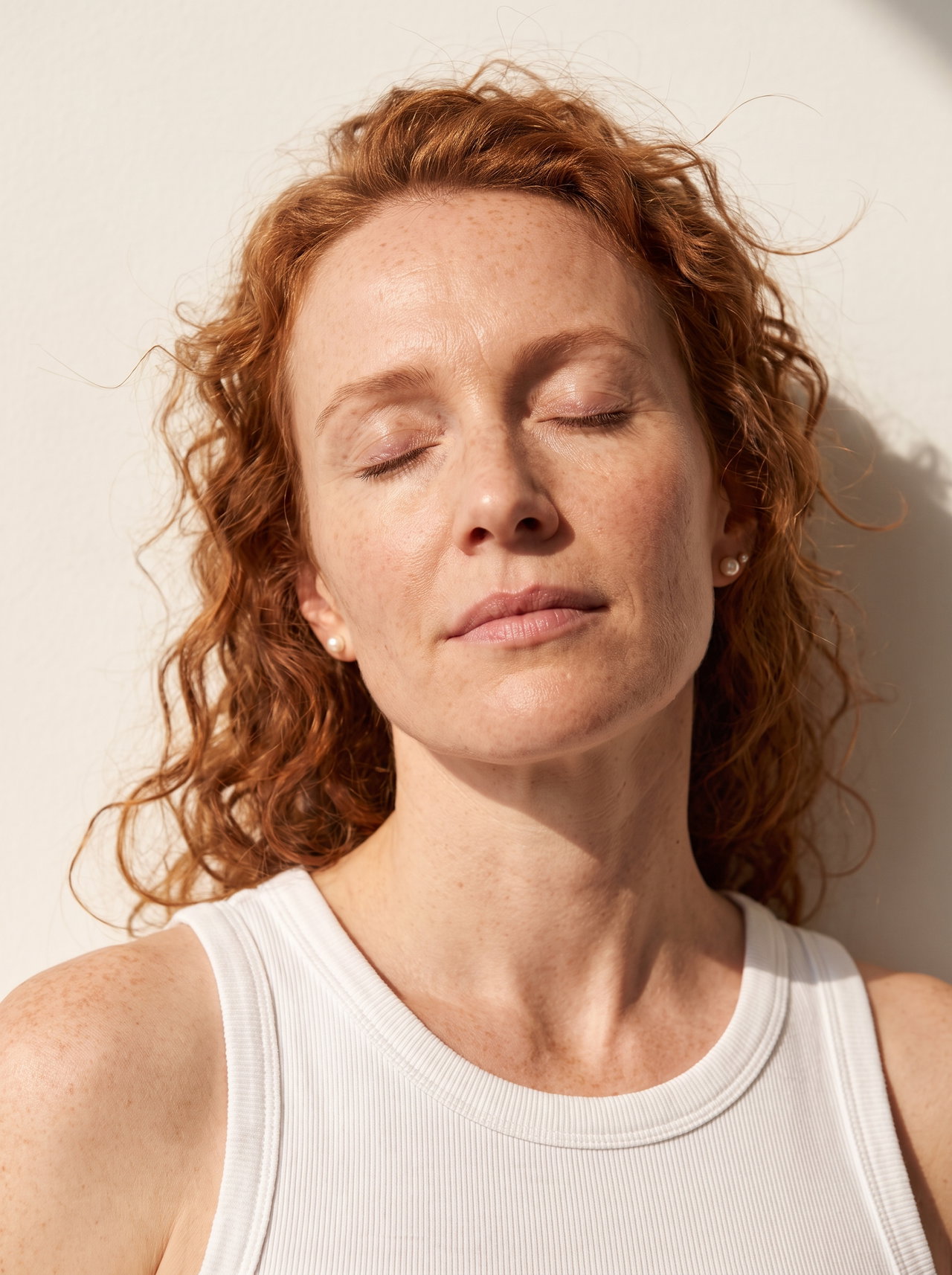 Portrait of Woman with Curly Copper Hair in Sunlight