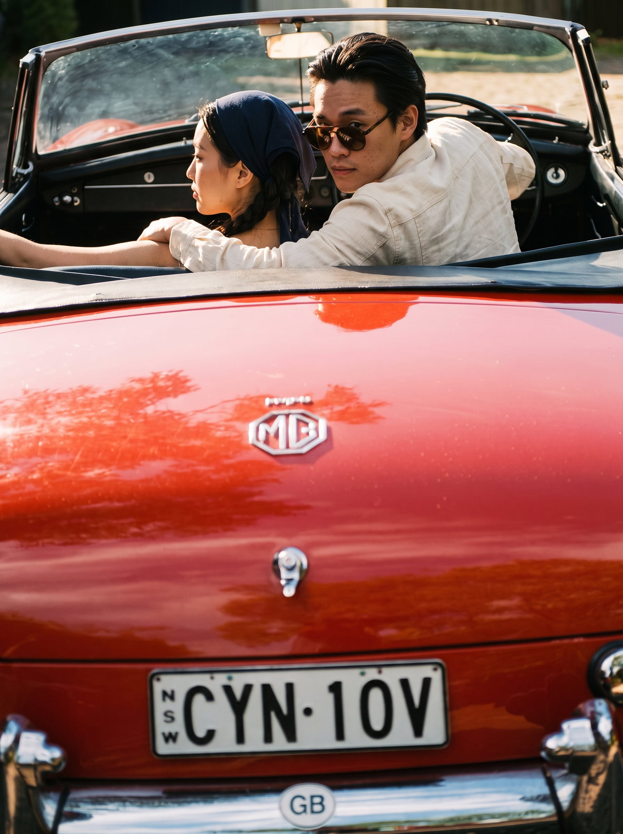 Couple in Red Vintage Convertible