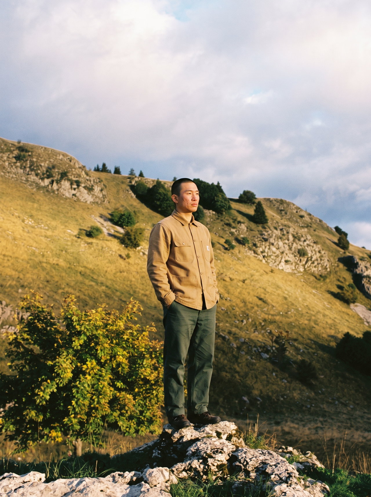 Man Standing on Rock in Alpine Landscape