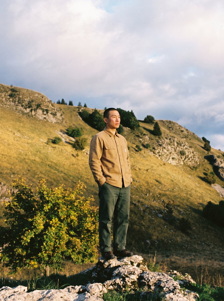 Man Standing on Rock in Alpine Landscape