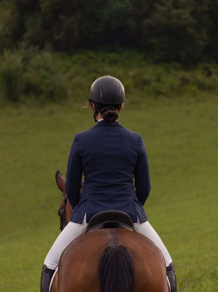 Rider in Navy Jacket on Bay Horse